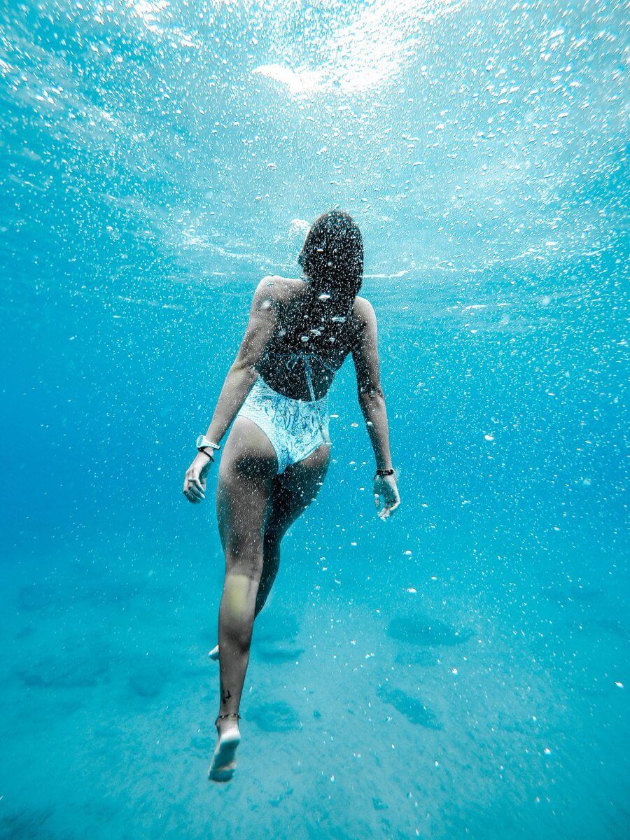 woman swimming under water